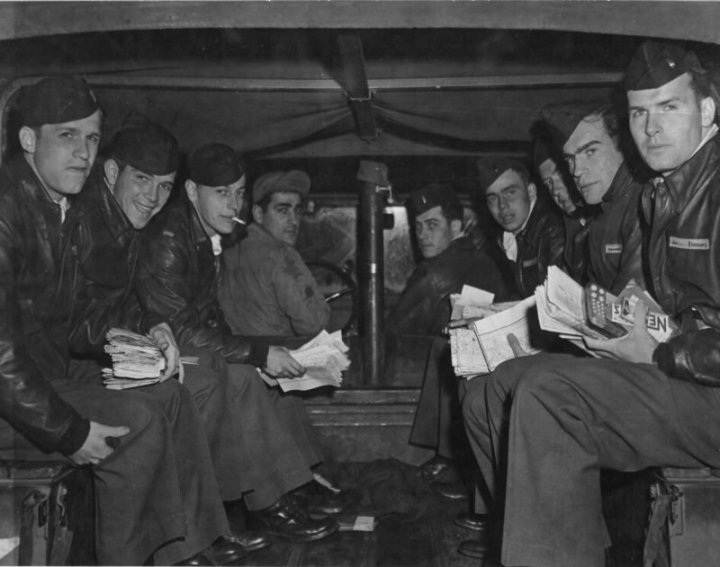 Pilots of the 336th being taken to their planes for the first leg of Operation Frantic II, the Russia Shuttle from June 21st to July 5th, 1944. Note the amount of paperwork! From Left: Lt. James C Lane, Medford, MA; Lt. George C. Smith, Los Angeles, CA; Lt. Charles H Shilke, Somerset, PA; Cpl. Anthony D. Fiore, Attleboro, MA; Lt. J.C. Norris, Amesa, TX (KIA on this mission); Lt. Donald R Emerson, Pembina, ND; Lt. Gilbert W Hunt, Hays, KS; Lt. George H Logan Jr., Montclair, NJ; and Lt. Joseph W Higgins, Philadelphia, PA. National Archives 53360 AC via littlefriends.co.uk
