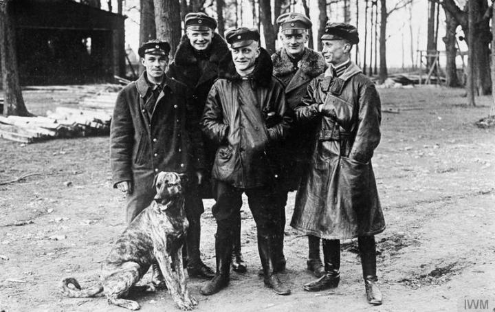 Jasta 11 pilots at Roucourt, France in March 1917, just days before Richthofen was shot down. Left to right are Vizefeldwebel Sebastian Festner (9 victories that month, killed on 23 April), Leutnant Karl-Emil Schäffer (14 victories), Oberleutnant Manfred von Richthofen (22 victories), Leutnant Lothar von Richthofen (14 victories) and Leutnant Kurt Wolff (21 victories). The dog is Moritz, Richthofen's beloved Danish hound. (IWM Q 42284)