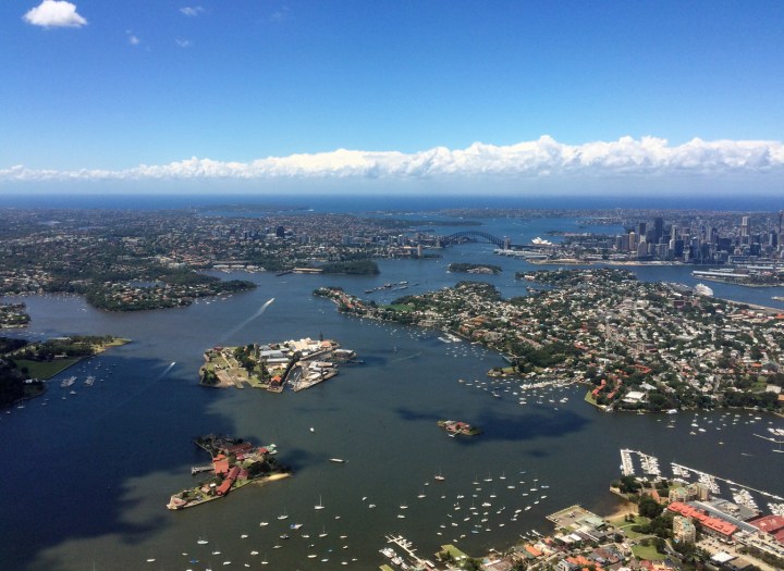 Sydney Harbour, looking east to the Heads. The long boat wakes mark the main flow of the harbour (Parramatta River) from the western suburbs and out under the Bridge. (© airscape Photo) 