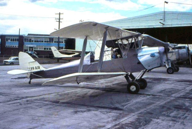 Hold that Tiger. VH-AJA, the Tiger Moth John Cameron used to beat up Sydney Harbour in 1975. The aircraft is a de Havilland Australia machine, (cn DHA 629) that served as A17-437. The Canadian style canopy is a later addition, now removed. This location is Bankstown Airport in 1971, so VH-AJA may not have been in Cameron's ownership at this time. (Photo by John Wheatley, courtesy of EdCoatesCollection.com) 