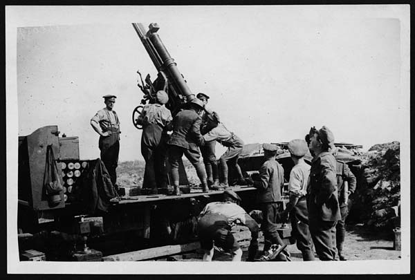'Driving away a Bosche plane.' An official  photograph taken during the battle of Menin Road Ridge at Passchendaele, September 1917. One gunner has had his ablutions interrupted by the appearance of a Taube. (National Library of Scotland digital.nls.uk/74547190)