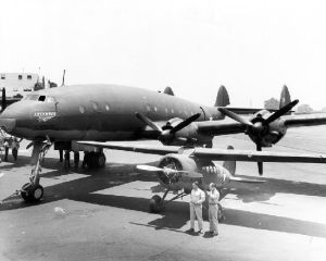 Prototype L-049/C-69-1-LO (c/n 1961, civil test registration NX25600 and USAAF serial 43-10309) on Lockheed's Burbank ramp in 1943, alongside a somewhat dwarfed UC-101 Vega 5C. (SDASM #00013538)