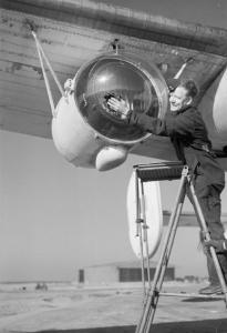 Ground crew polish the cover of a 22 million candela Leigh Light, fitted to a Coastal Command Liberator GR.V. (IWM CH 13997)