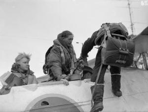 A Swordfish pilot climbs down from his "pulpit-like cockpit" on board HMS Tracker (D24), during North Atlantic convoy duty in October 1943. (IWM A19730)