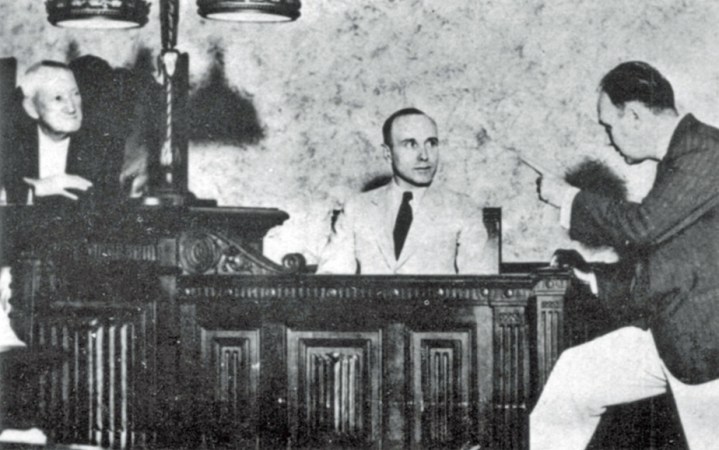 State Attorney N Vernon Hawthorne cross examines Lancaster during the murder trial. Lancaster faced the electric chair if found guilty. (© UPI)