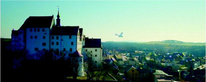 Falling with style... The completed replica leaves the castle roof (from by the clock tower, centre) and picks up flying speed. (© WIndfall Films)