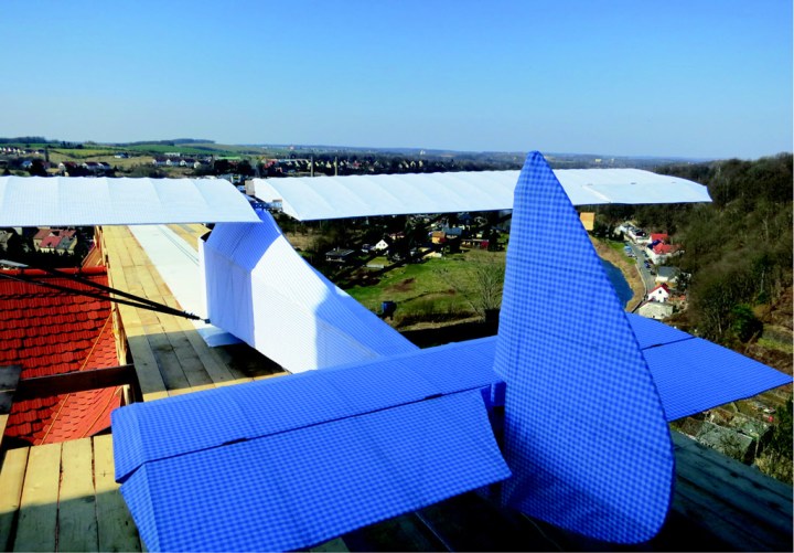 The finished glider on its rooftop runway, with the landing field framed under the wing. (© Ben Watkins)