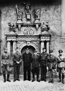 Senior officers of the Oflag IVC in front of Colditz Castle chapel. From left to right: Unidentified Yugoslavian Army Captain; Colonel de Smet, Belgian Army; Admiral Józef Unrug, Polish Navy; General Tadeusz Piskor, Polish Army; Colonel David Stayner, the Dorsetshire Regiment, British Army; General Le Bleu, French Army; Major E. Engles, Dutch Army. © IWM (HU 20269)