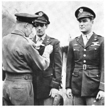 Gentile receives his DFC from Gen. Eisenhower on April 11th, 1944, while Col. Don Blakeslee stands to attention. 