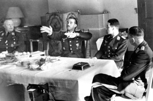 Ever the fighter pilot, (then Oberstleutnant) 'Dolfo' Galland (hands raised), talks with Werner Molders and Theo Osterkamp (to his left, respectively) at the latter's birthday in April 1941. (Bundesarchiv, Bild 183-B12018 / CC-BY-SA 3.0, via wikipedia)